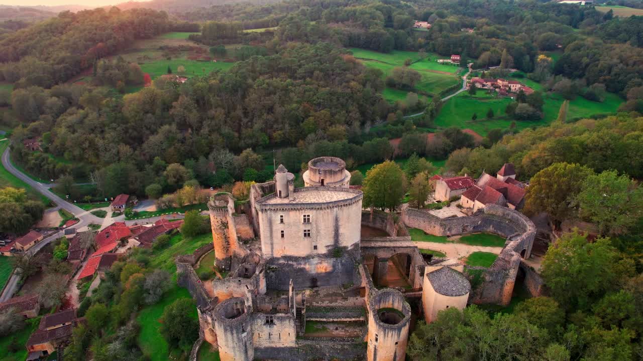 Aerial view of Bonaguil Castle, ancient walls and lush landscape scene