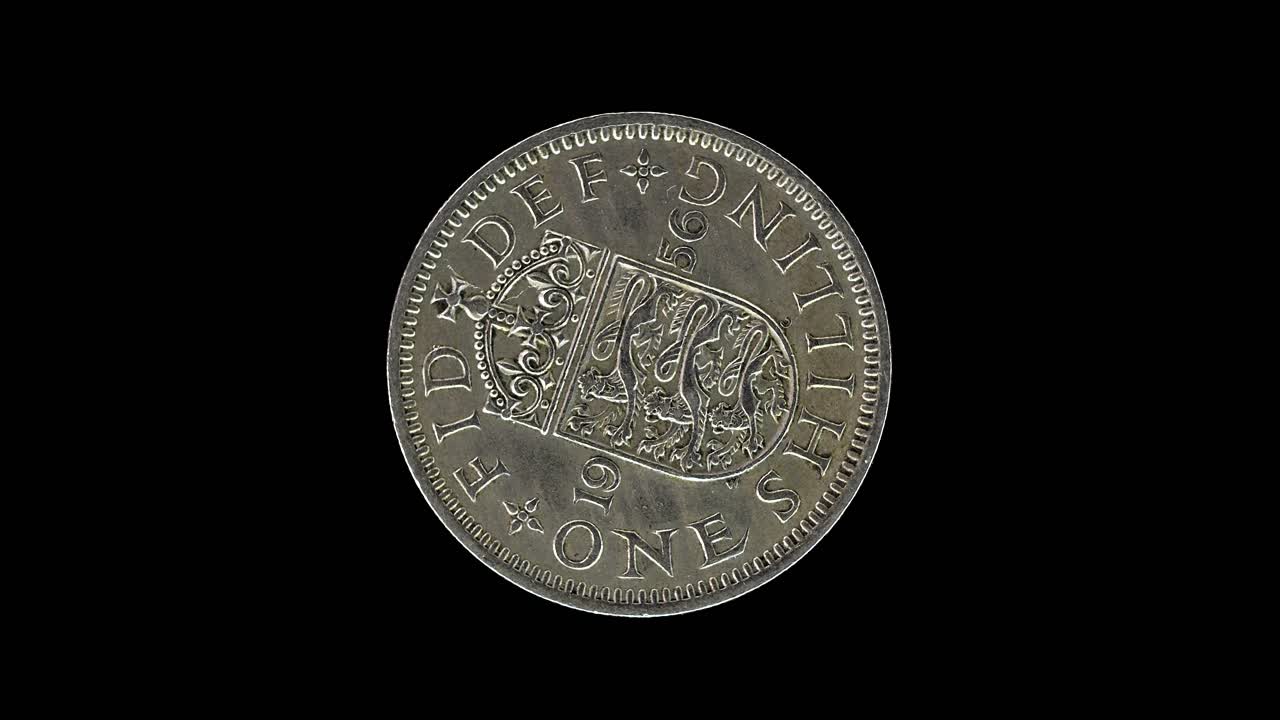 United Kingdom 1956 one shilling coin reverse with crowned English shield of arm rotating on black background