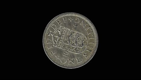 united kingdom 1956 one shilling coin reverse with crowned english shield of arm rotating on black background