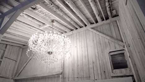 Gorgeous-and-fashionable-wedding-gown-displayed-in-a-beautiful-white-modern-room-with-a-crystal-chandelier-filing-the-room-with-light-at-Manoir-Montpelier,-Quebec