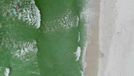 beach activities concept - popular tourist spot in florida for spring break vacationers - aerial overhead drone view