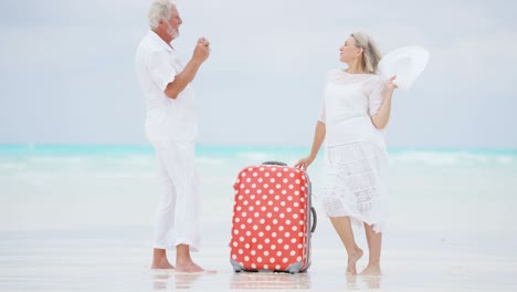 senior caucasian couple in white on caribbean beach