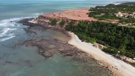 panning in to beachside brazilian famous cliff pipa chapadao