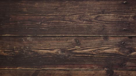 orange juice in red and green glass on wooden background - stop motion