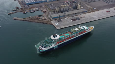 departure of a giant luxury cruise ship at sete harbor port france aerial view