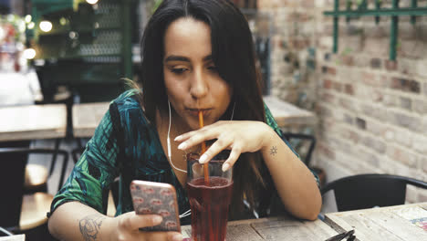 Young-woman-sipping-a-cold-drink