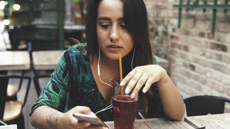 young woman sipping a cold drink