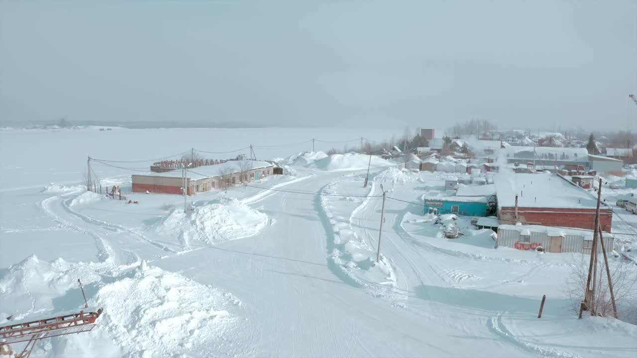 Snowy Village by a Frozen Lake