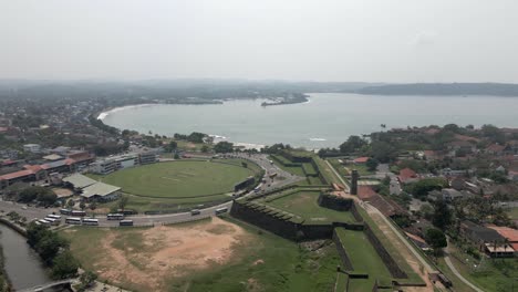 Flyover-of-cricket-pitch-in-roundabout-outside-Galle-Fort,-Sri-Lanka