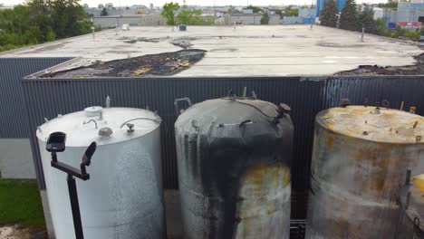 aerial view over burnt industrial containers, extinguished fire of hazardous materials