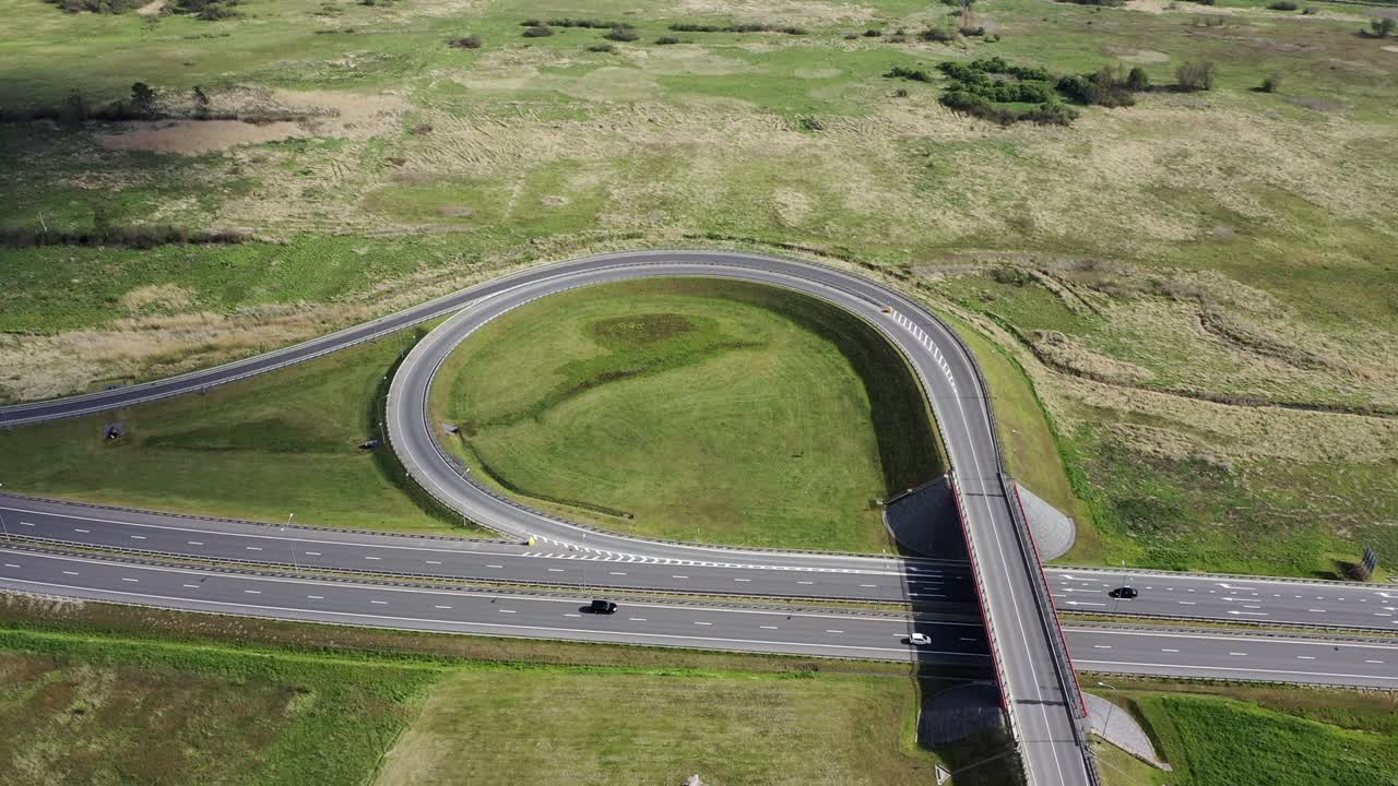 Top view in summer on ring road and passing cars. Development of transport infrastructure in rural areas and small towns.