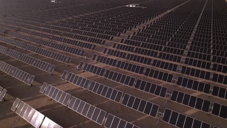 aerial-view-of-solar-panel-photovoltaic-farm-in-Joshua-Tree-National-Park-California-USA,-drone-fly-above-solar-panel-revealing-scenic-landscape