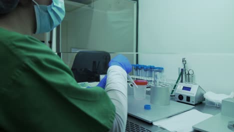 sobre el hombro, la enfermera usa una pipeta