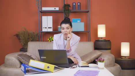 home office worker young woman thinking looking at camera.