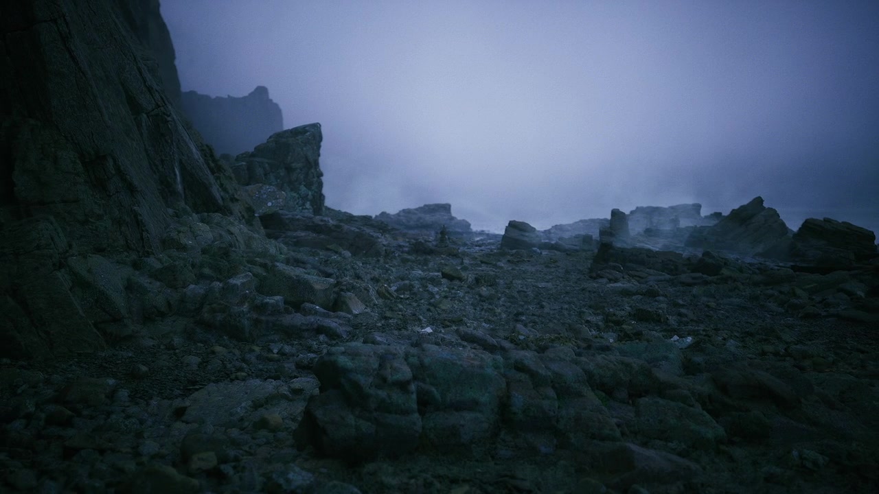 Pebblefilled foreground guides eye toward distant misty horizon