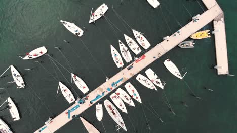 sailboats are moored at the dock in lindau in this twisting high-angle shot