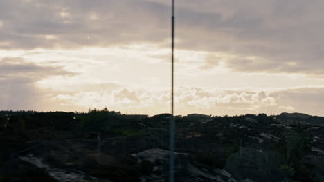 slow motion shot of the beautiful golden sun rays lighting up norway