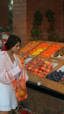 woman shopping for fruits at a market