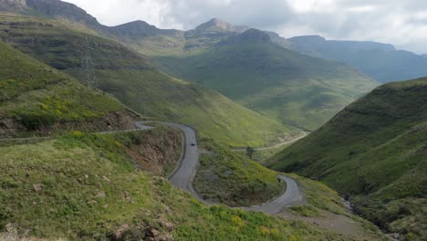 Car-drives-down-scenic-and-remote-Moteng-Pass-in-Lesotho-mountains