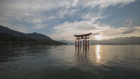 torii gate at sunset on miyajima island, japan