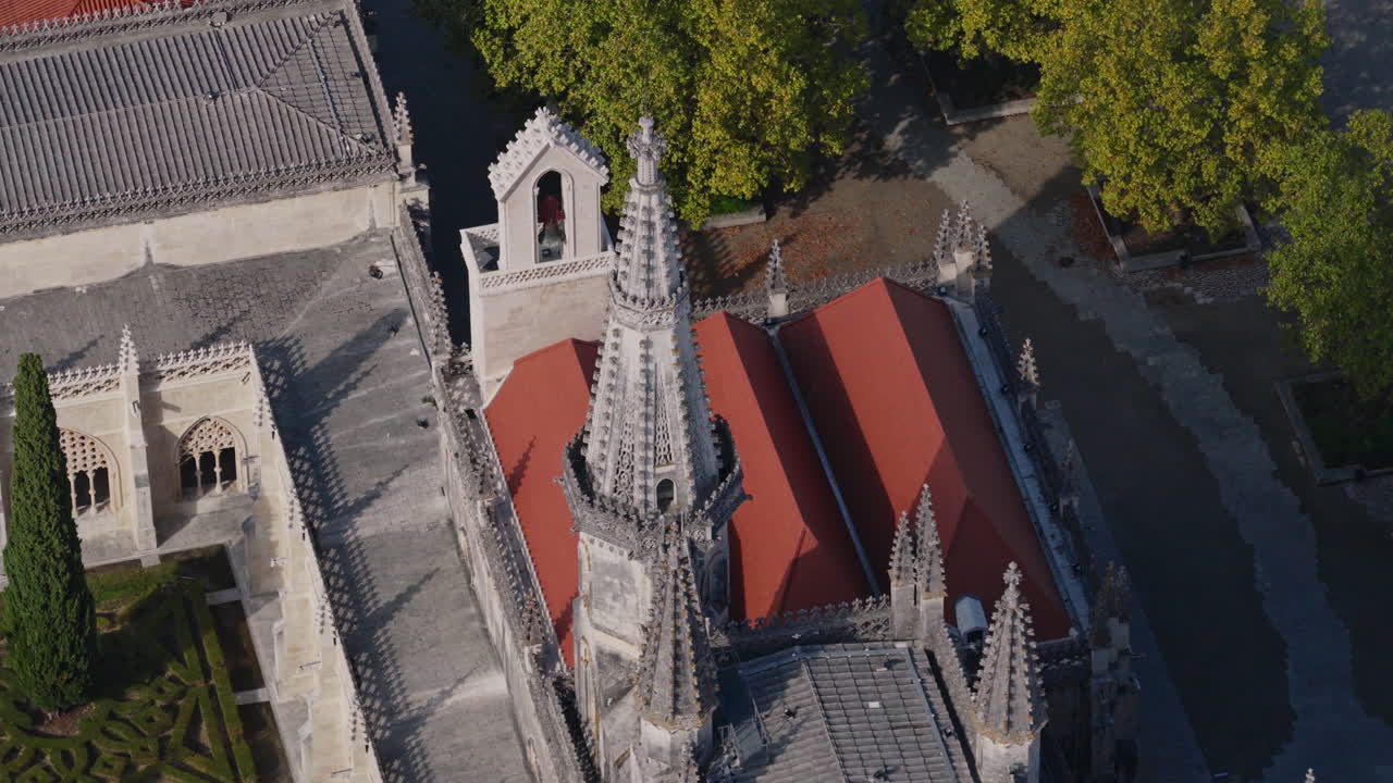 Mosteiro da Batalha aerial slow orbit clockwise, wide establishing view of monastery with town context