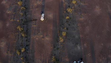 tilt-up and push-in over an arizona desert with parked rv campers at sunset