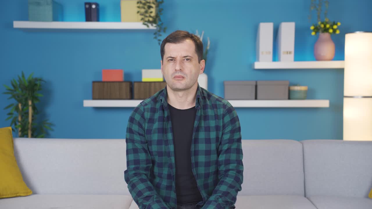 A tough guy who looks at the camera as a suspect and a listener.