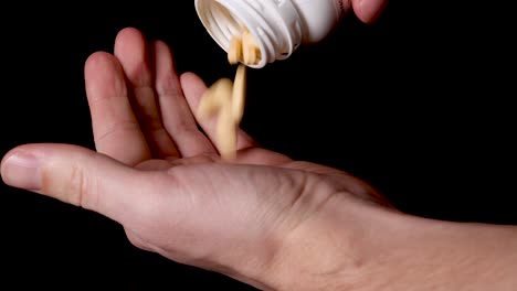 prescription drug medication pills being poured into hand