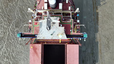 epic cinematic aerial drone shot flying over the length of an abandoned cargo ship in bangladesh. downward angle