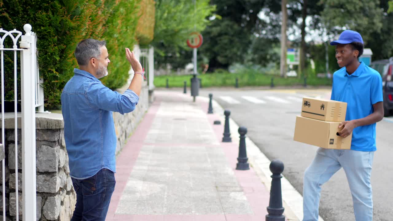 A delivery man handing a package to a customer