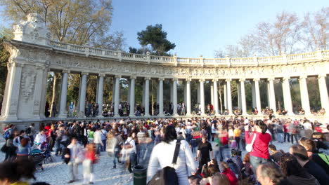 crowded park plaza with monumental architecture
