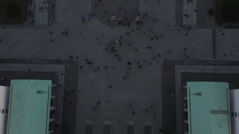 AERIAL:-Slow-Birds-View-Overhead-shot-of-Brandenburg-Gate-roof-with-Quadriga-statue-close-up-and-people-on-the-ground