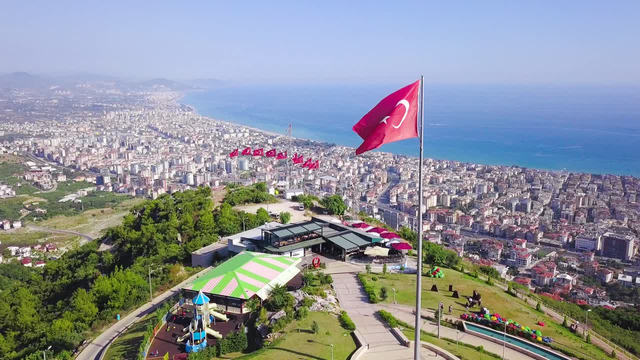 Turkish Coastline Cityscape from Hilltop with Flag
