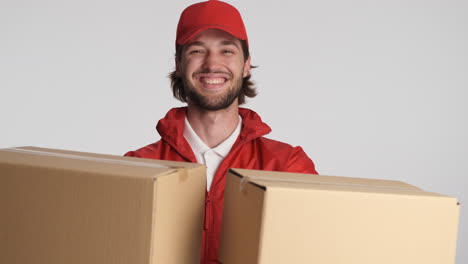 caucasian delivery man in front of camera on white background.