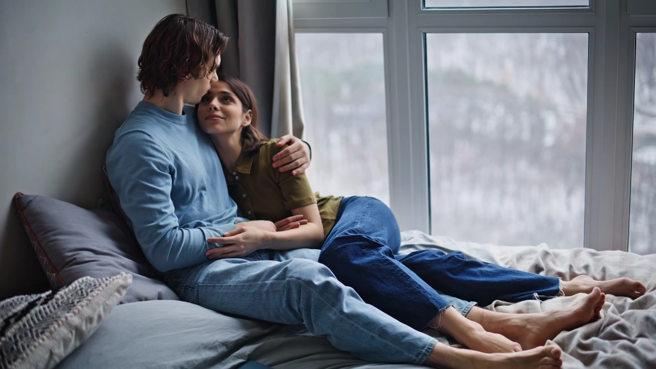 Love sweethearts lying mattress dreaming together embracing at gloomy morning