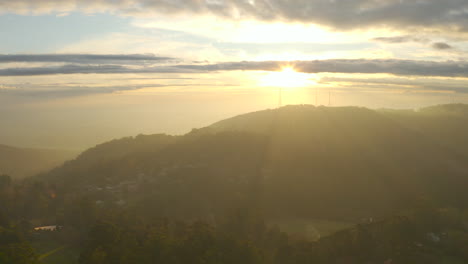 Slow-descent-aerial-perspective-looking-toward-television-towers-ontop-of-Mount-Dandenong,-Victoria,-Australia