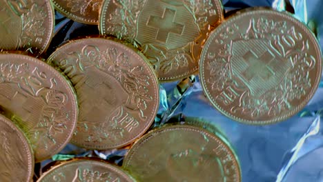 Close-up-spinning-shot-showing-many-rarely-golden-vreneli-gold-coins-of-swiss-franc