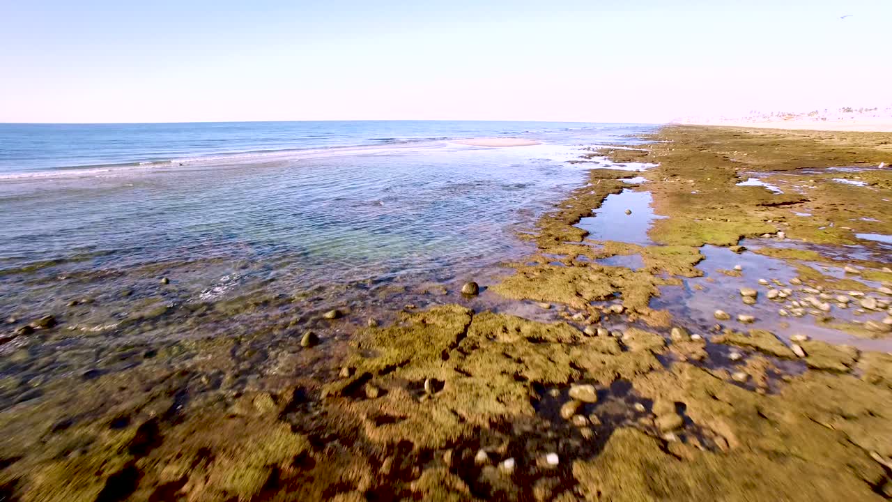 Aerial high angle flyover the tide pools and intertidal beaches , Rocky Point, Mexico