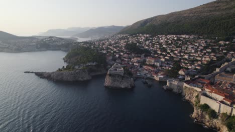 Croatia-Aerial:-Dubrovnik's-Fort-Lovrijenac,-coast-and-mountain-backdrop