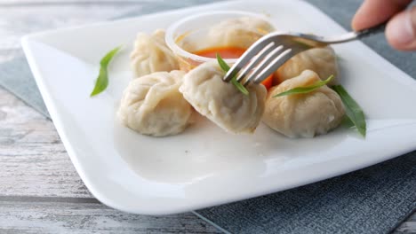 close up of chicken momo dumpling on a plate