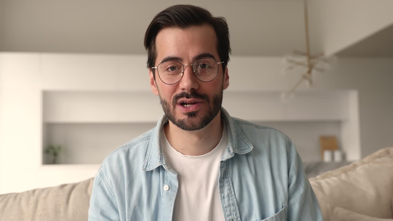 Happy man in eyeglasses holding web camera zoom call.
