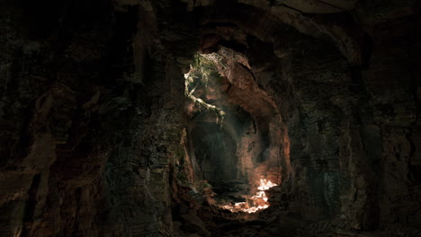 light shining through a dark cave entrance