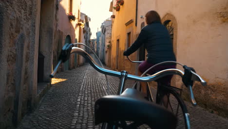 cycling through a charming cobblestone street in an old european town