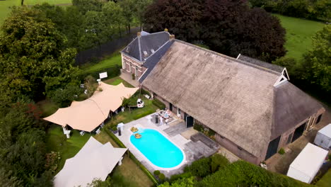 aerial of beautiful villa with swimming pool in rural netherlands