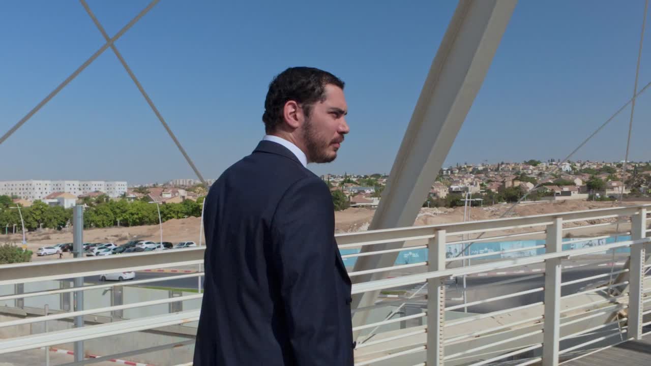 Man in suit on a bridge