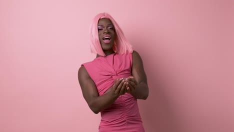 cheerful black transgender throwing confetti in air against pink background