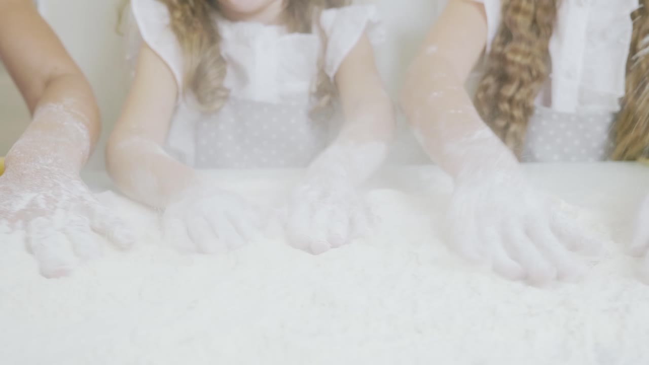 Children playing with flour in the kitchen