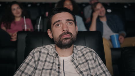 man watching a movie in a theater