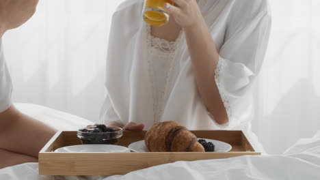 couple enjoying a romantic breakfast in bed