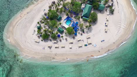 drone view of small picturesque beach with sun beds in tiny island. summer vacation fiji.